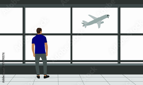 A male character stands in an airport building and looks out the window at an airplane taking off