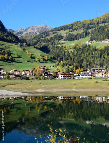 Herbstliche Landschaft mit Dorf und See - Kuppelwies im Ultental, Südtirol, Italien, Europa, Berglandschaft, Bergdorf photo