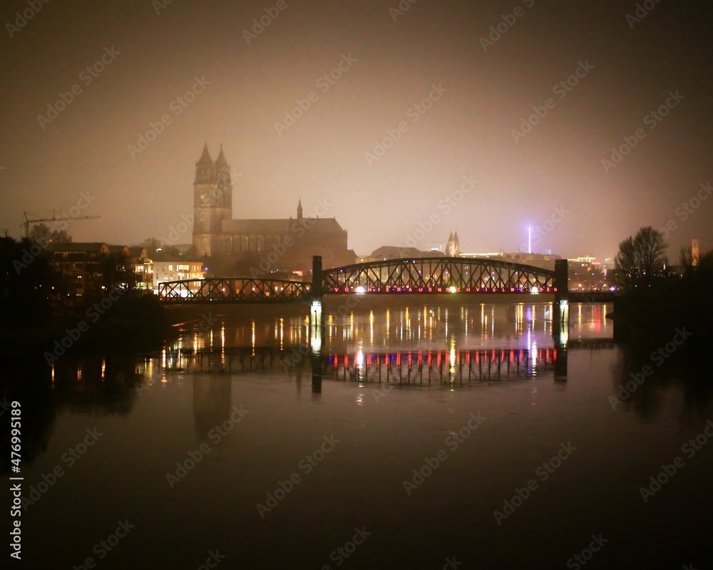 Misty view on Magdeburg and river Elbe. The text on the bridge says von hier aus noch viel weiter (even further from here)