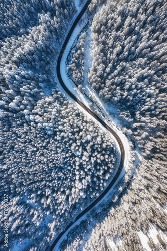 Natural winter landscape from air. Aerial view on the road and forest at the winter time. Winter chill. Forest and snow. The photo is in high resolution. © biletskiyevgeniy.com