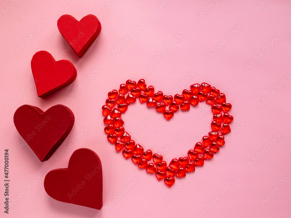 Valentine's day concept. Hearts on a red background. Gift paper boxes.