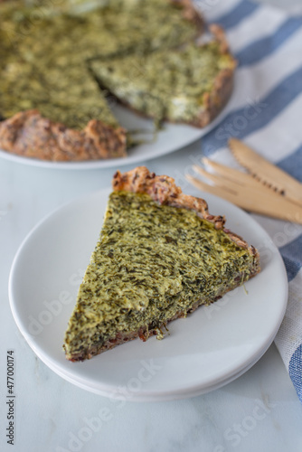 home made Quiche with spinach on a table