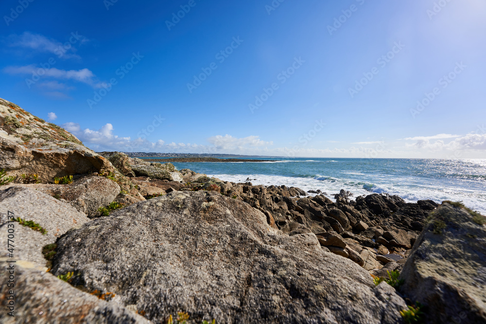 Rocks on the Breton coast. Landscape with sea water against blue sky. Rocky background. France, Brittany, Audierne, Lervily. Rocks on the Breton coast. Landscape with sea water against blue sky. Rocky background. France, Brittany, Audierne, Lervily.