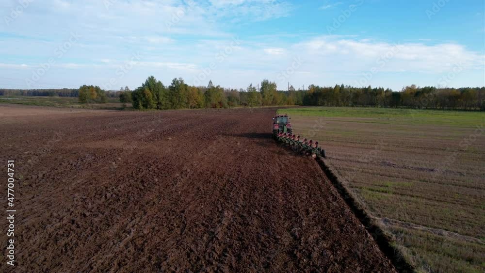 Tractor with Plough on Plowed. Ploughing and Soil Tillage. Agricultural Tractor on Cultivation Field for Sowing Seeds. Tractor During Field Cultivating. Planting and Seeding Equipment. Tractor with Plough on Plowed. Ploughing and Soil Tillage. Agricultural Tractor on Cultivation Field for Sowing Seeds. Tractor During Field Cultivating. Planting and Seeding Equipment.
