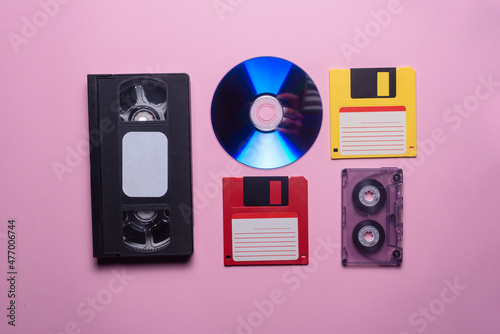 VHS, audio cassette, compact disk and floppy disk background. photo