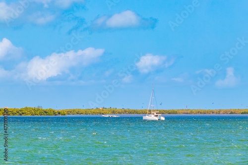 Panorama landscape view Holbox island turquoise water and boats Mexico. © arkadijschell