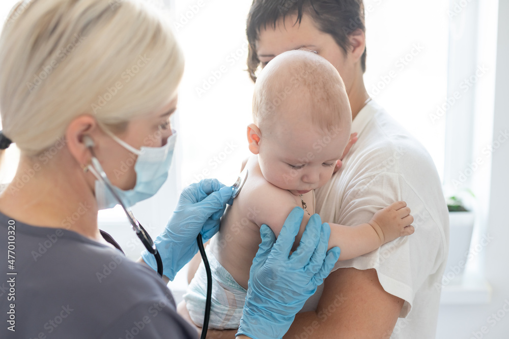 Doctor giving baby girl checkup in doctor office Doctor giving baby girl checkup in doctor office