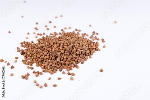 Pile of buckwheat on white background. Buckwheat seeds isolated on white background 