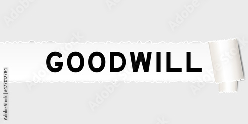 Ripped gray paper background that have word goodwill under torn part