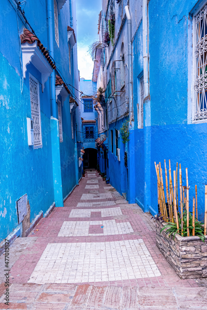 Blue colored residential alley leading to houses on both side, the blue city in the Morocco
