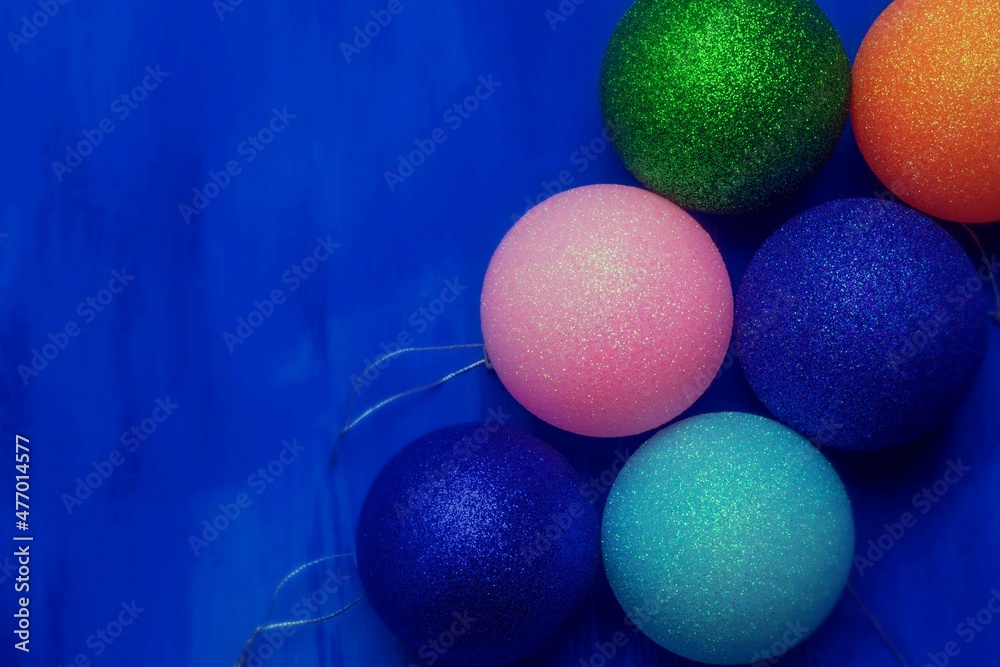 A small amount of Christmas decorations lies on a blue background A small amount of Christmas decorations lies on a blue background