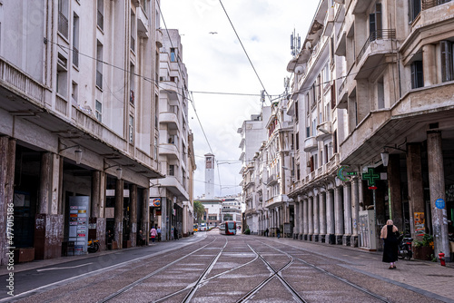 Casablanca, Morocco. October 10, 2021. Tramway paths through buildings with city hall in background against cloudy sky