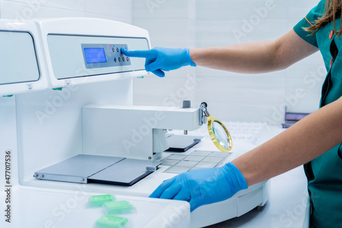Foto Laboratory assistant works at paraffin wax dispenser tissue embedding machine