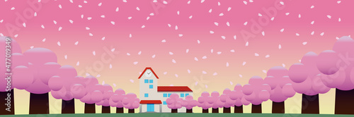 春の桜並木の奥に見える校舎・園舎 