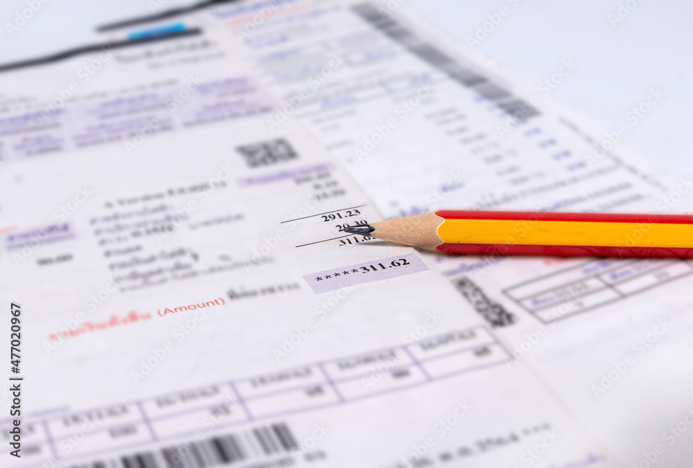 Utility energy bill with pencil blurred background Utility energy bill with pencil blurred background
