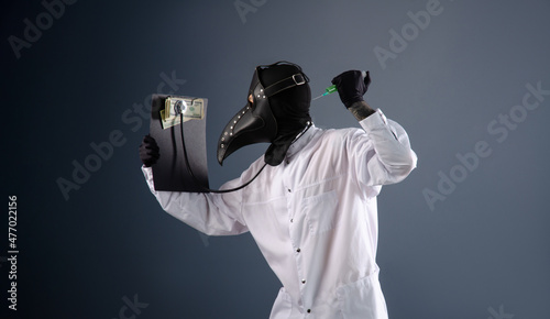 doctor in a dressing gown, in a plague doctor's mask, is vaccinating