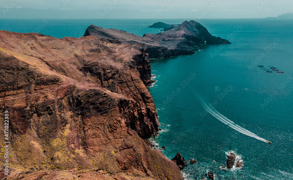 Peninsula, cape Ponta de Sao Lorenco in Atlantic ocean. Coastline with red cliffs, rocks and turquoise waves. Madeira island, Portugal. Aerial photography from drone. Breathtaking landscape.