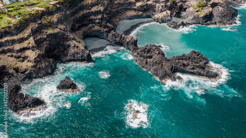 Atlantic ocean coastline with cliffs rocks and turquoise waves. Madeira island  Portugal. Aerial drone photography. Panoramic landscape. Sea background.