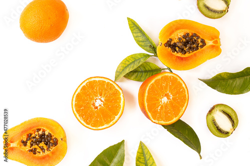 Orange, papaya and kiwi cut in half on white background