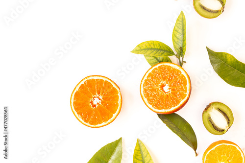 Orange cut next to green leaves