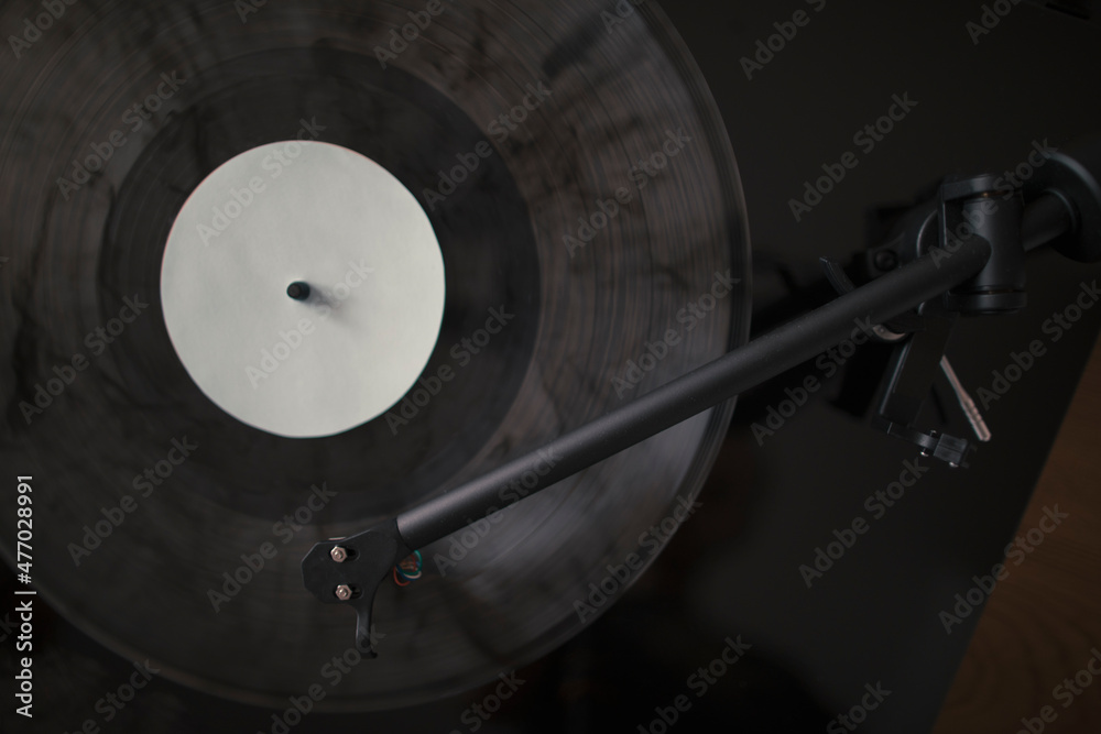 Turntable tonearm playing vinyl record