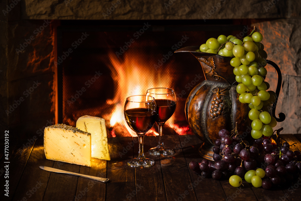 Wine cellar with wine glasses, cheese, grapes