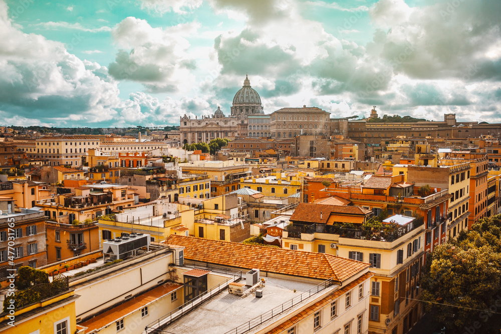 Panoramic view of Vatican Saint Peter Basilica, Rome, Italy. Beautiful italian cityscape with dramatic clouds and sun rays. Historical buildings.