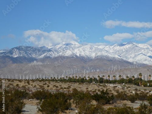snow covered mountains and wind turbines in palm springs