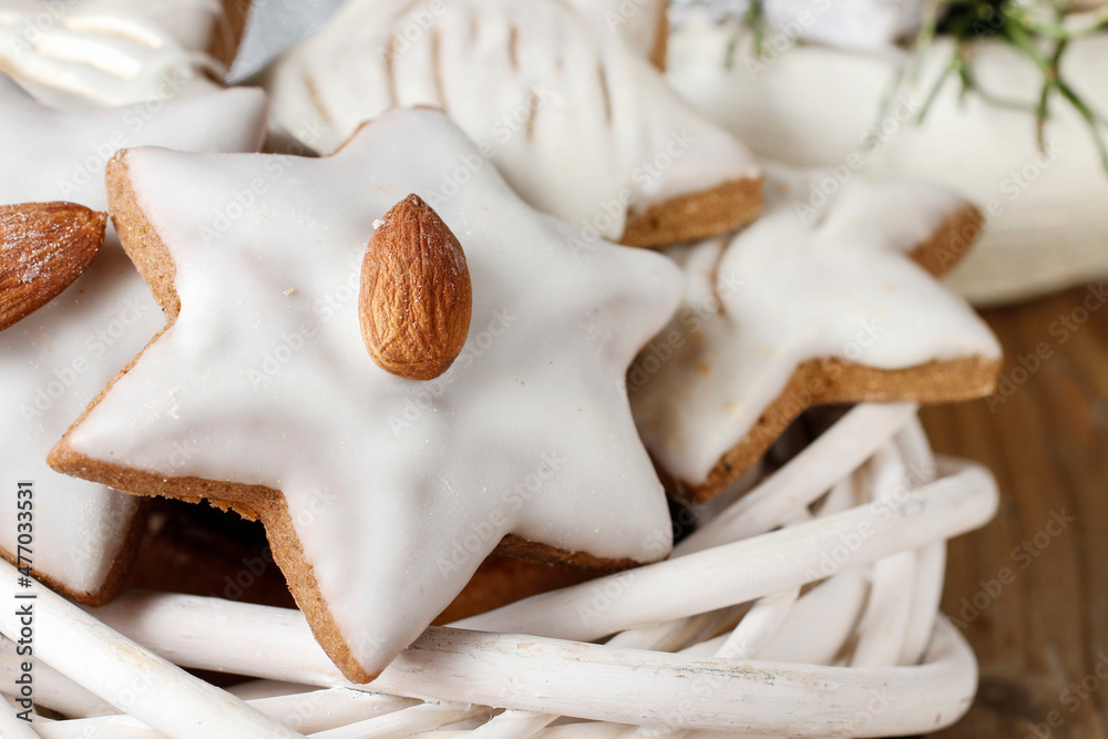 Gingerbread cookies in star shape decorated with almonds.