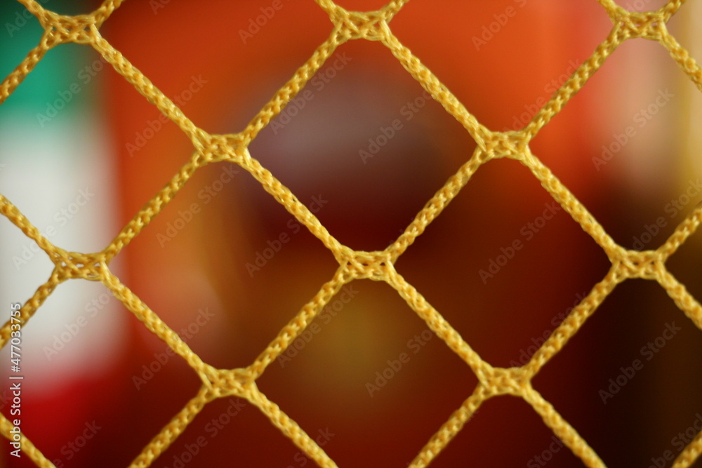 Fototapeta premium Yellow braided net in the foreground