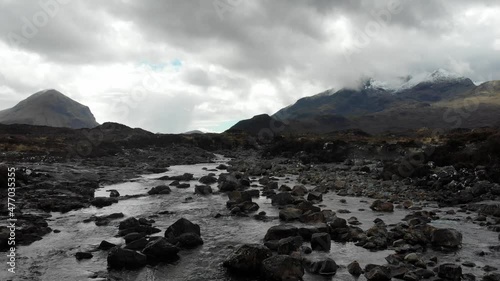 Aerial footage from the centre of the Isle of Skye near it's Sligachan Old Bridge, close to Portree and the Scottish Highlands captures the vast plains between the Cullin Mountain Range. photo