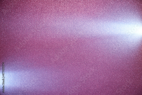 Two long horizontal light blue beams of light on grainy dark purple background