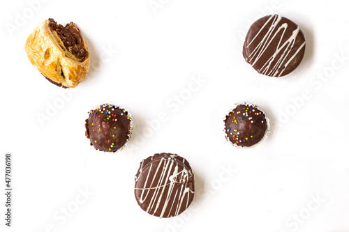 Chocolate covered cakes on white background