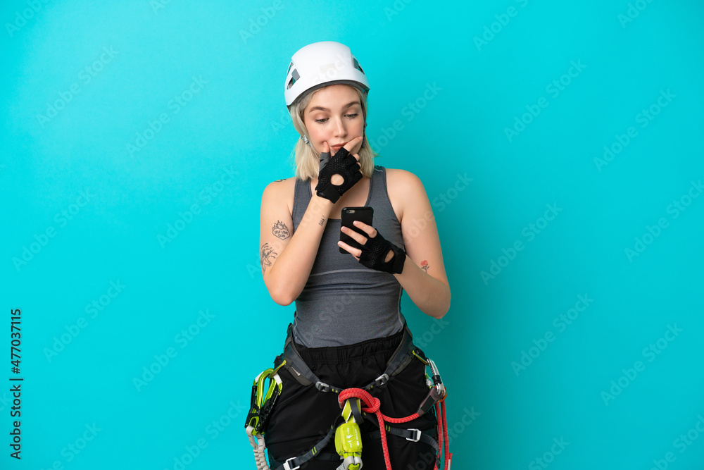 Young caucasian rock-climber woman isolated on white background thinking and sending a message