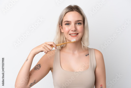 Young caucasian woman isolated on white background with a toothbrush and happy expression