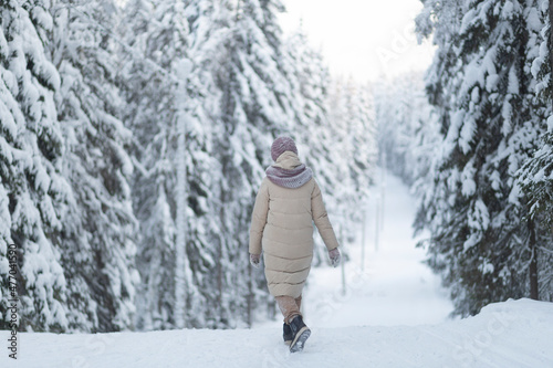 A woman walks in the winter forest.A walk through the forest on a day off.