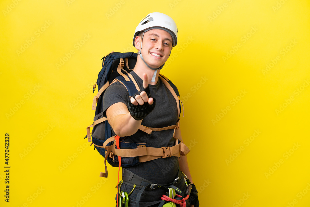 Young rock climber Brazilian man showing and lifting a finger Young rock climber Brazilian man showing and lifting a finger