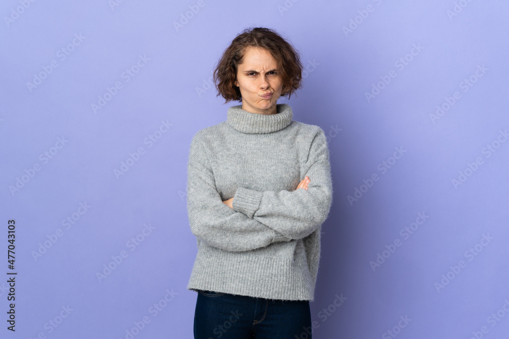 Young English woman isolated on purple background with unhappy expression