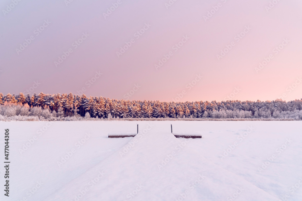 Beautiful winter sunrise landscape view to the frozen lake 