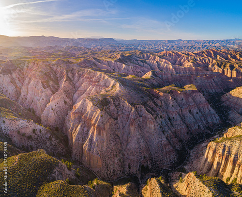 Aerial view over the colorful eroded badlands of the Gorafe desert, los Coloraos, at sunset, Andalusia, Spain photo