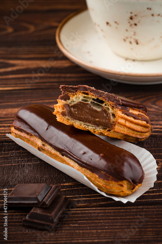 Traditional french dessert eclair with custard and chocolate icing Sweet pastry products