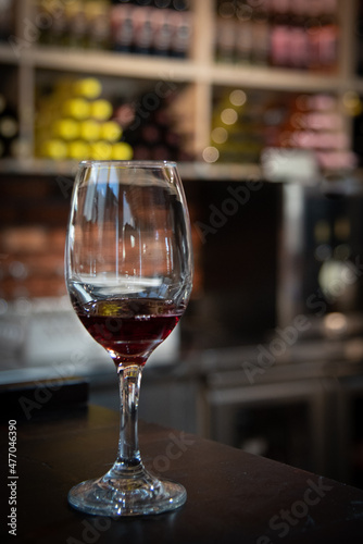 Glass of red wine on a bar in winery. Wine aroma tasting