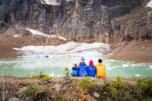 A family of four overlooking a melting glacier at Edith Cavell Meadows in Jasper National Park photo