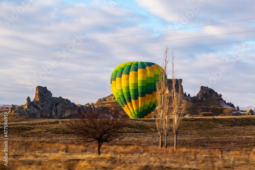 Hot air balloons flying over spectacular Cappadocia. Beautiful view of hot air balloons floating in sunrise blue sky over the mountain landscape of fairy chimneys