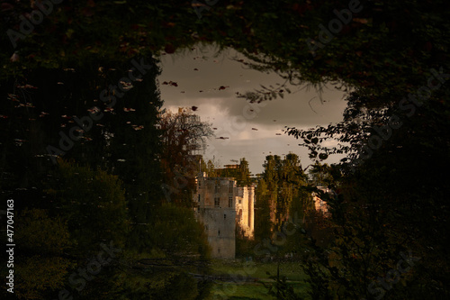 The reflection of eerie Beaufort castle of Luxembourg in the lake