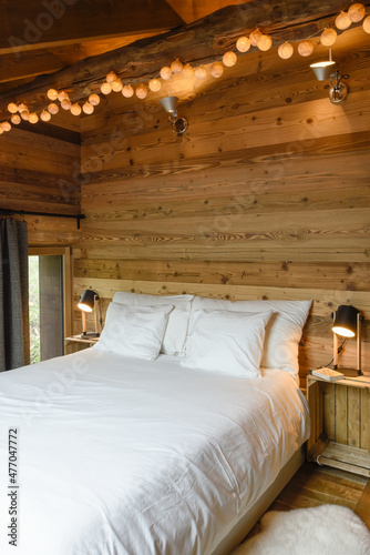 Bedroom in a chalet with an attic wooden ceiling photo