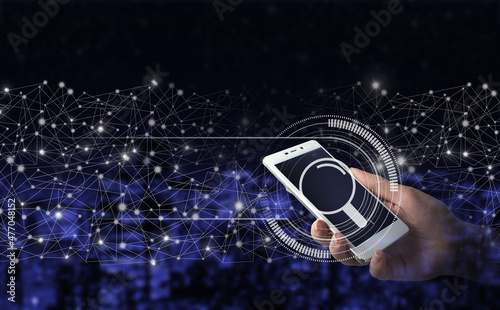 Searching information data on internet networking concept. Hand hold white smartphone with digital hologram search data sign on city dark blurred background. © Alexa Mat