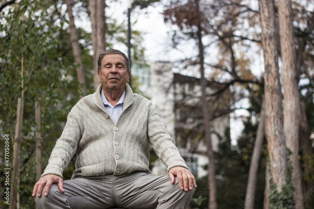 Old man relaxing outdoors with eyes closed. Portrait of senior man looking thoughtful Old man relaxing outdoors with eyes closed. Portrait of senior man looking thoughtful