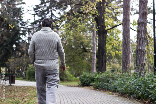 Senior man walking and relaxing in park