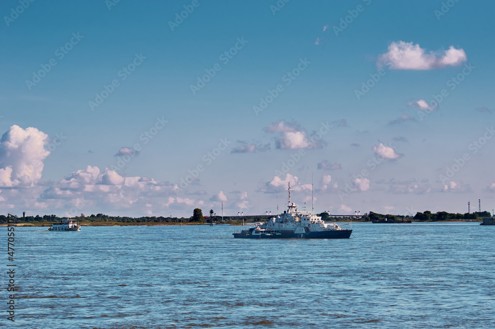 Ships on the river in the summer. Coast Guard boats and a small cruise ship. Partly cloudy. Amur River, Blagoveshchensk, Russia. Ships on the river in the summer. Coast Guard boats and a small cruise ship. Partly cloudy. Amur River, Blagoveshchensk, Russia.
